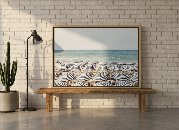 Canvas wall art with a natural timber surround standing on a bench in an industrial loft bedroom