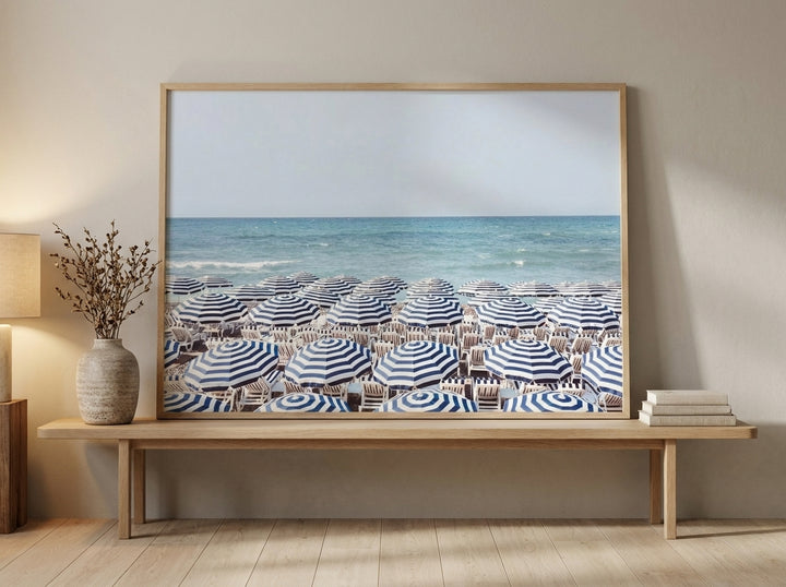 Modern wall art print standing on a bench in a warm Japandi bathroom