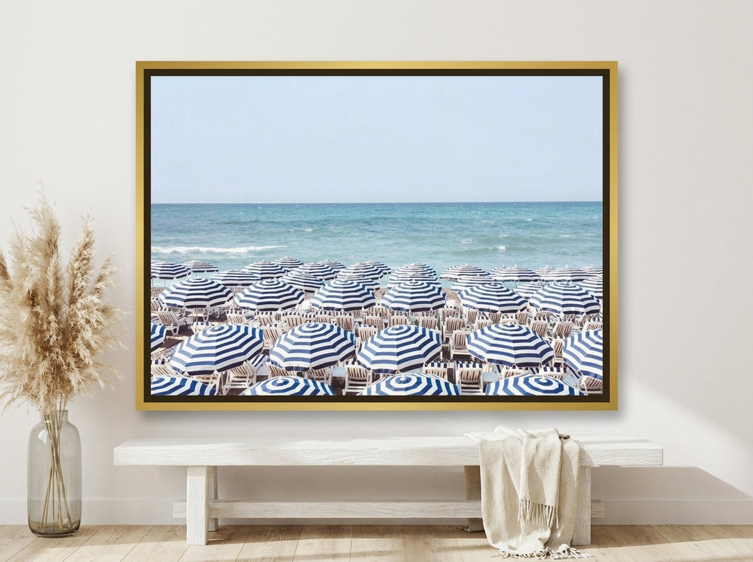Canvas wall art with a gold leaf surround styled on the wall in a coastal living room