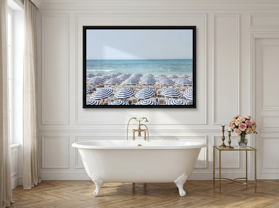 Canvas wall art with a black surround styled on the wall in a Parisian bathroom