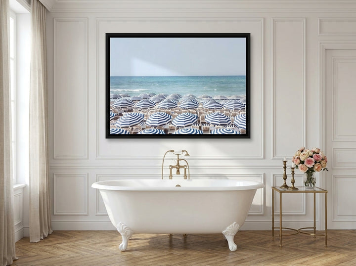 Canvas wall art with a black surround styled on the wall in a Parisian bathroom