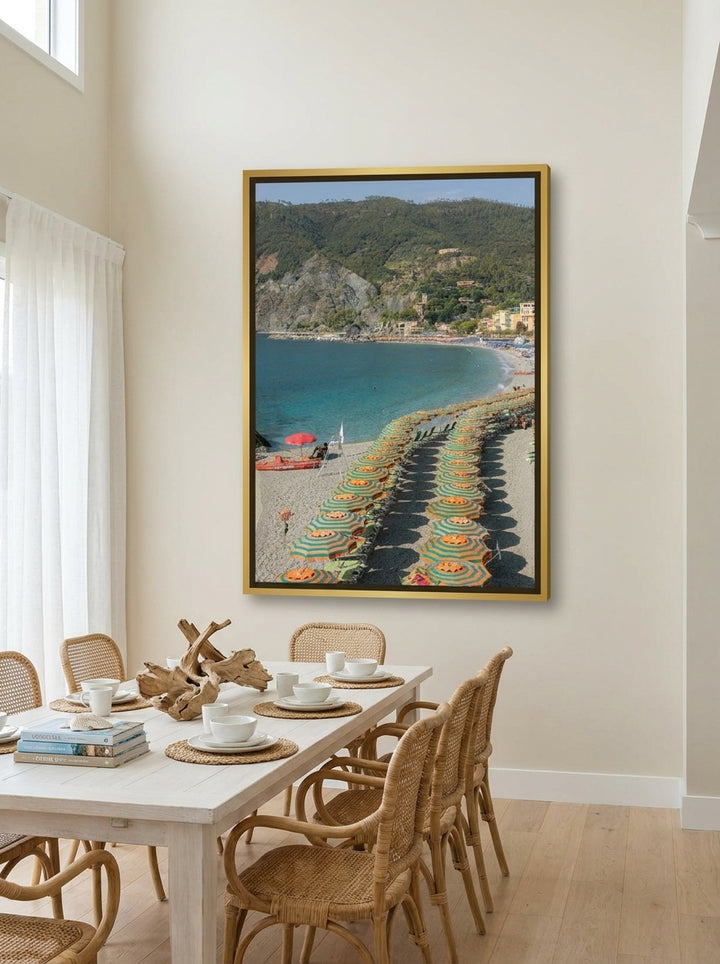 Oversized statement canvas wall art with a gold leaf surround styled on the wall in a coastal dining room