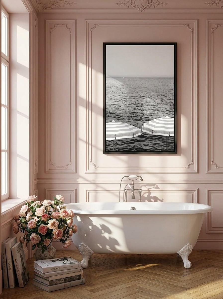 Canvas wall art with a black surround styled on the wall in a Parisian bathroom