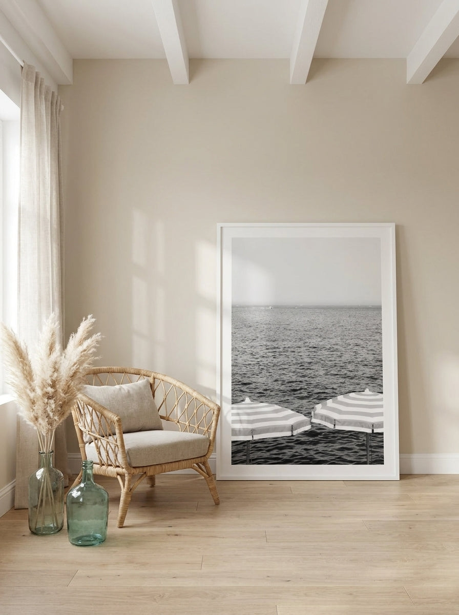 Oversized statement modern wall art print leaning against the wall in a coastal bedroom