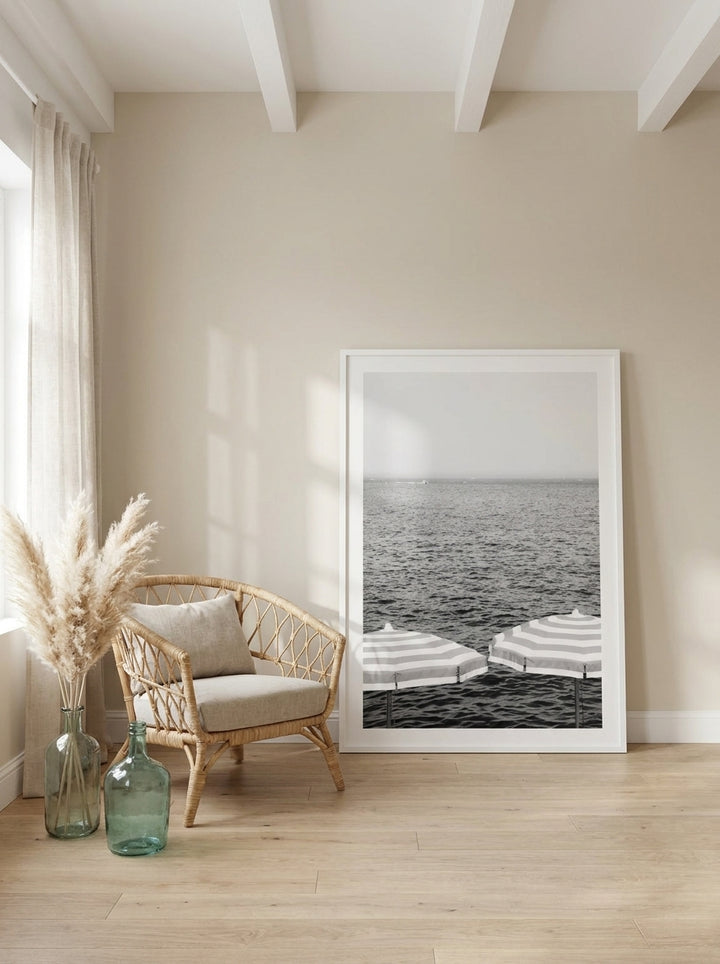 Oversized statement modern wall art print leaning against the wall in a coastal bedroom