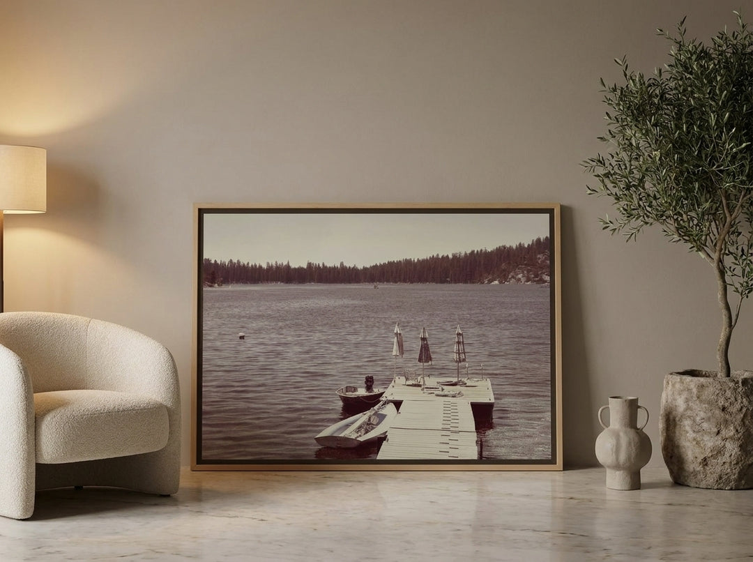 Canvas wall art with a natural timber surround leaning against the wall in a luxe bedroom