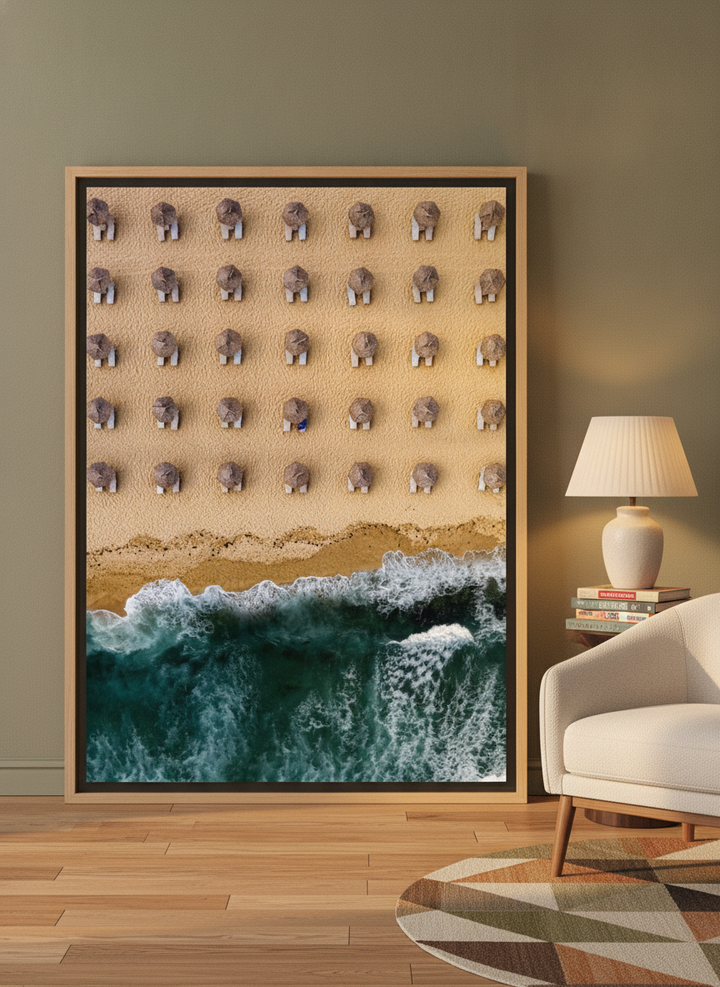 Oversized statement canvas wall art with a natural timber surround leaning against the wall in a mid-century living room