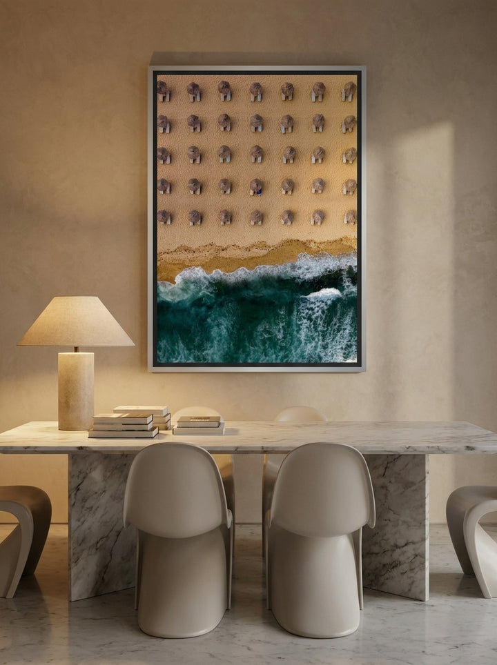 Oversized statement canvas wall art with a silver leaf surround styled on the wall in a luxe dining room