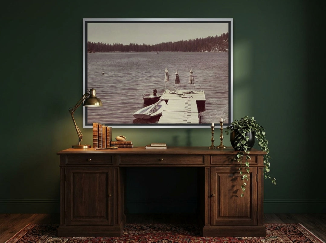 Canvas wall art with a silver leaf surround styled on the wall in a moody home office