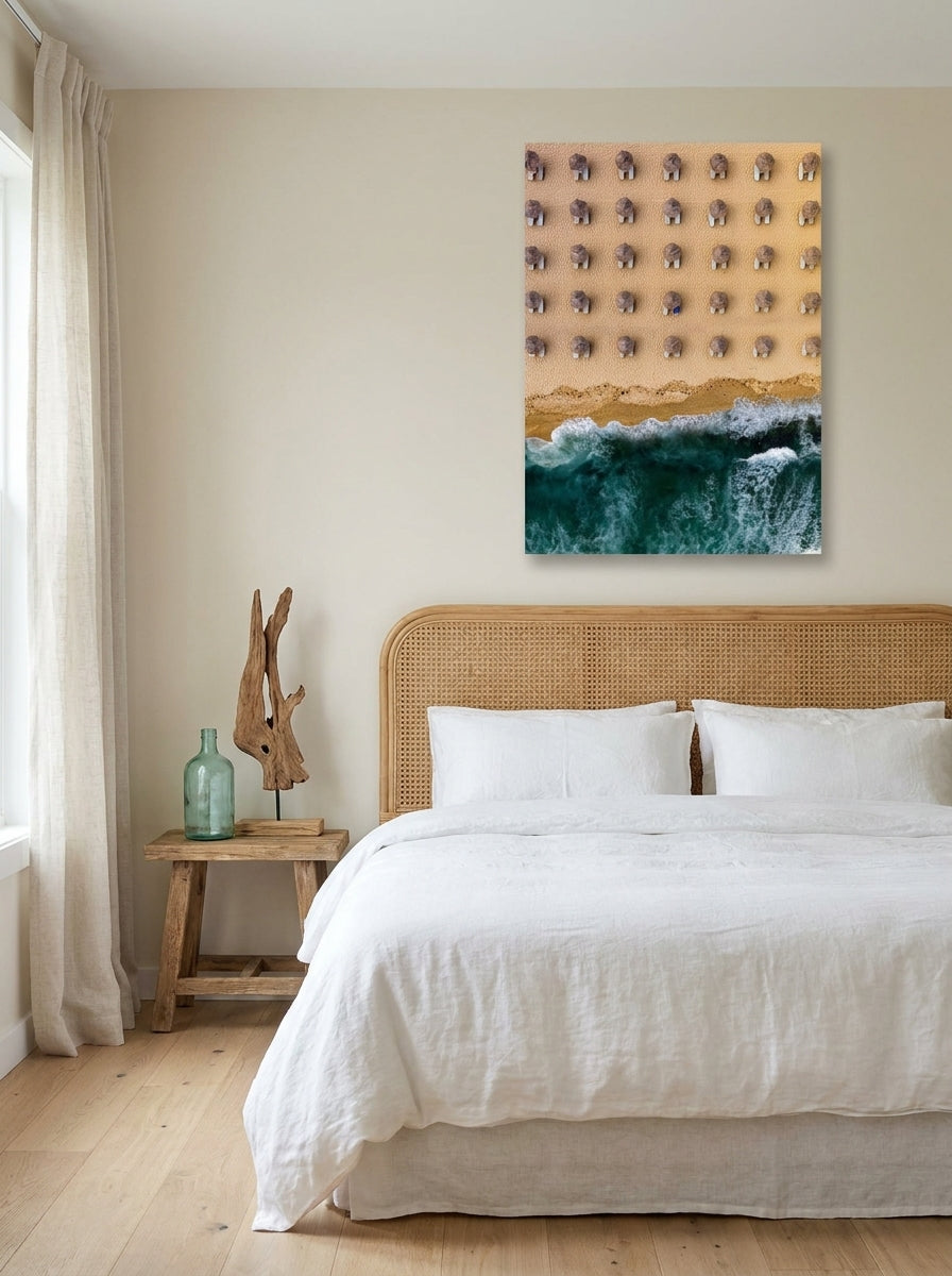 Stretched canvas wall art styled on the wall in a coastal bedroom
