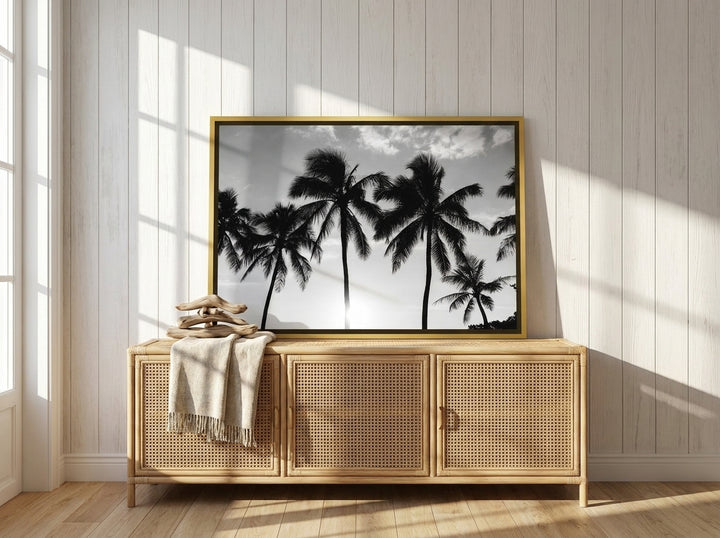 Canvas wall art with a gold leaf surround standing on a sideboard in a coastal living room