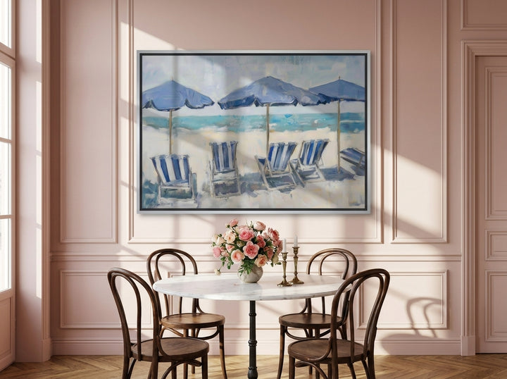 Canvas wall art with a silver leaf surround styled on the wall in a Parisian dining room
