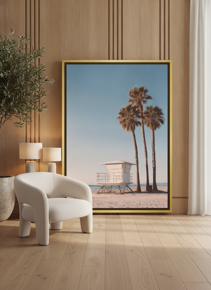 Canvas wall art with a gold leaf surround leaning against the wall in a luxe bathroom