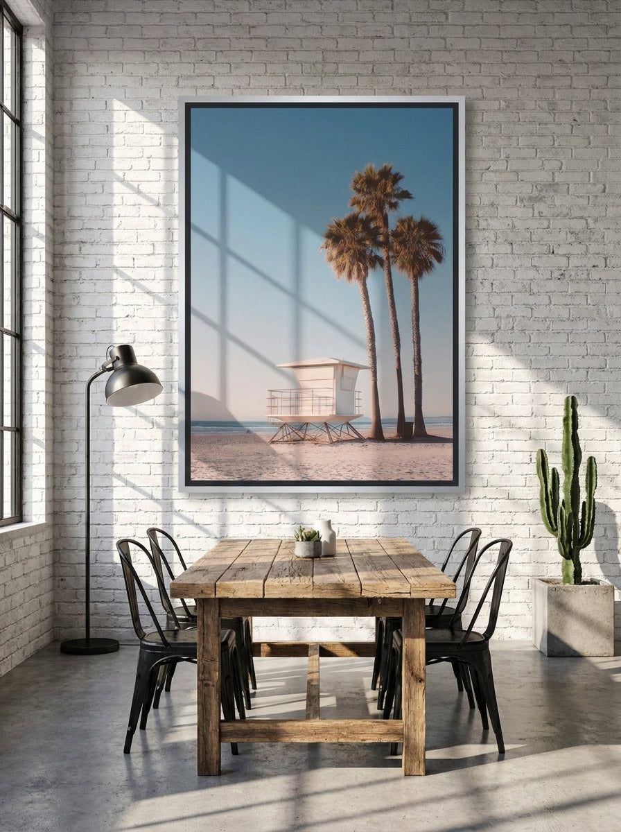 Oversized statement canvas wall art with a silver leaf surround styled on the wall in an industrial loft dining room
