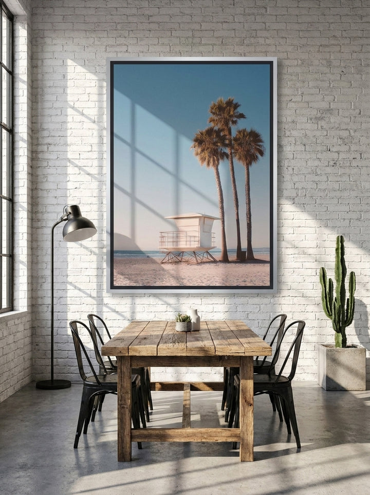 Oversized statement canvas wall art with a silver leaf surround styled on the wall in an industrial loft dining room