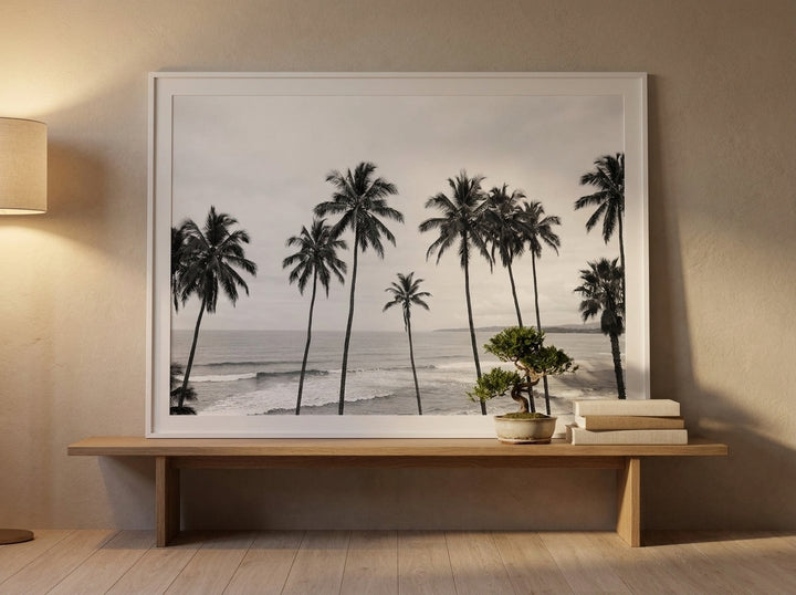 Modern wall art print standing on a bench in a warm Japandi bedroom