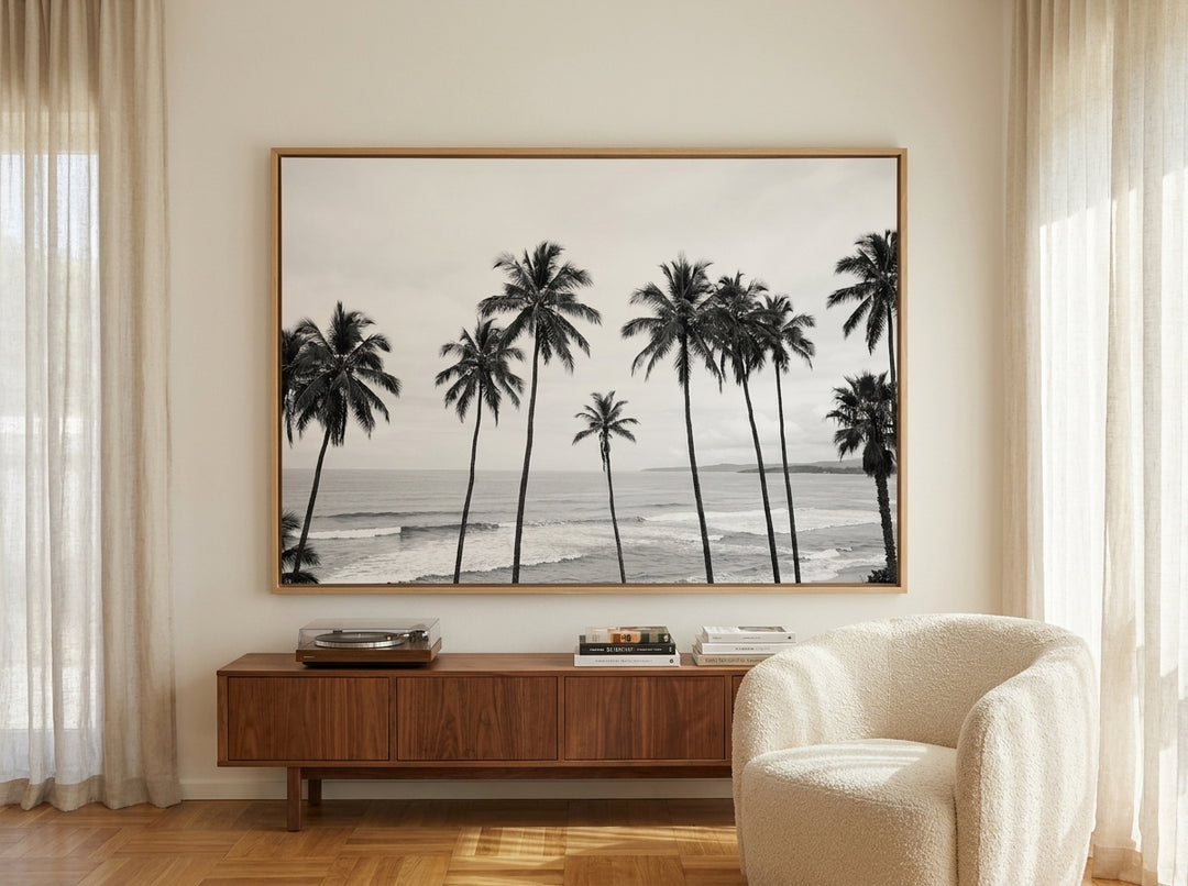 Oversized statement canvas wall art with a natural timber surround styled on the wall in a mid-century living room