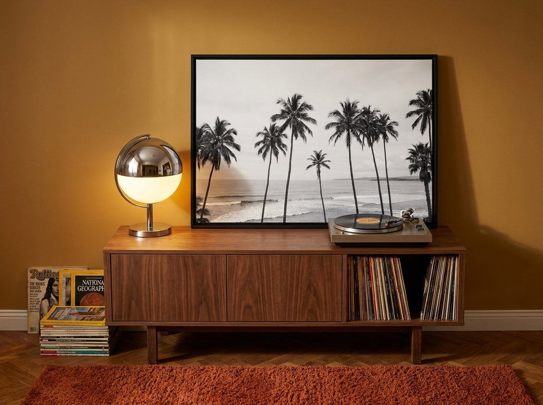 Canvas wall art with a black surround standing on a sideboard in a retro 70s bedroom