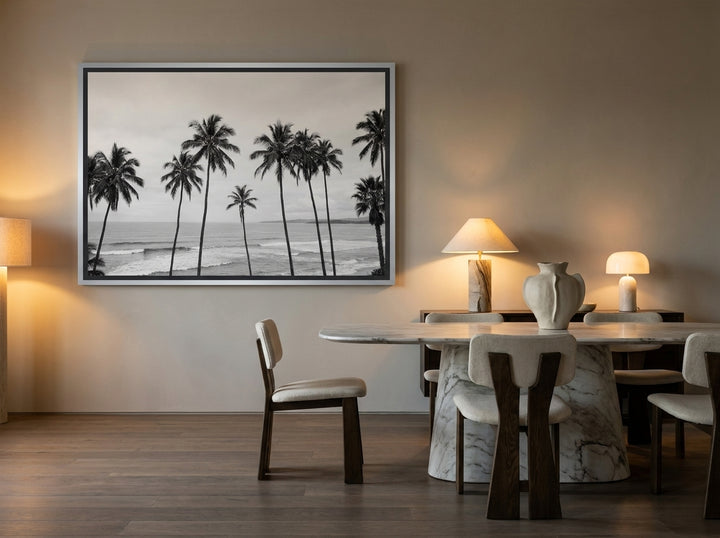 Oversized statement canvas wall art with a silver leaf surround styled on the wall in a luxe dining room
