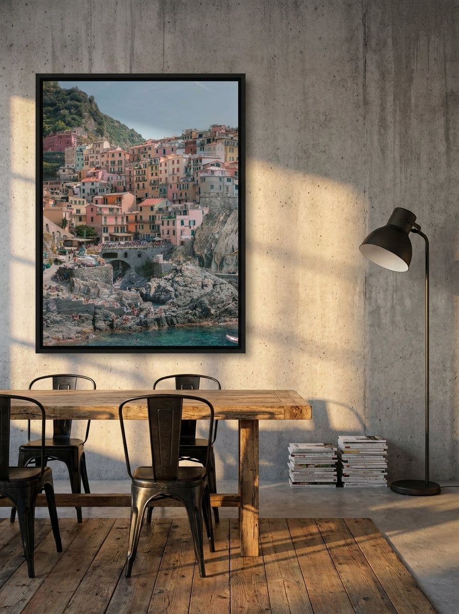 Oversized statement canvas wall art with a black surround styled on the wall in an industrial loft dining room