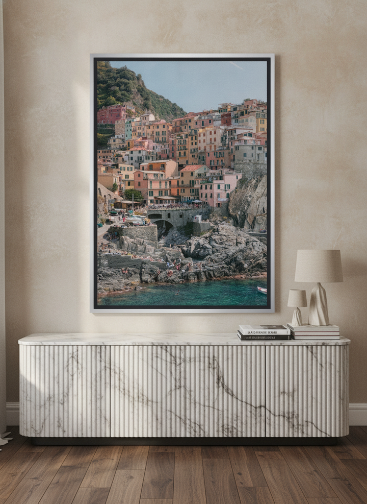 Canvas wall art with a silver leaf surround standing on a sideboard in a luxe home office