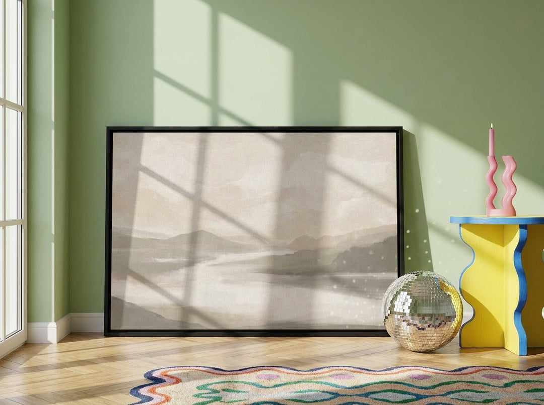 Canvas wall art with a black surround leaning against the wall in a colourful eclectic living room