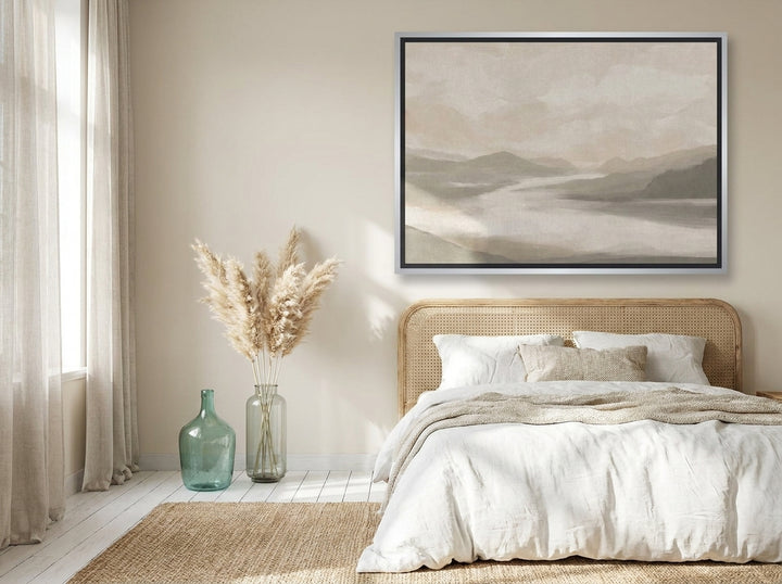 Oversized statement canvas wall art with a silver leaf surround styled on the wall in a coastal bedroom