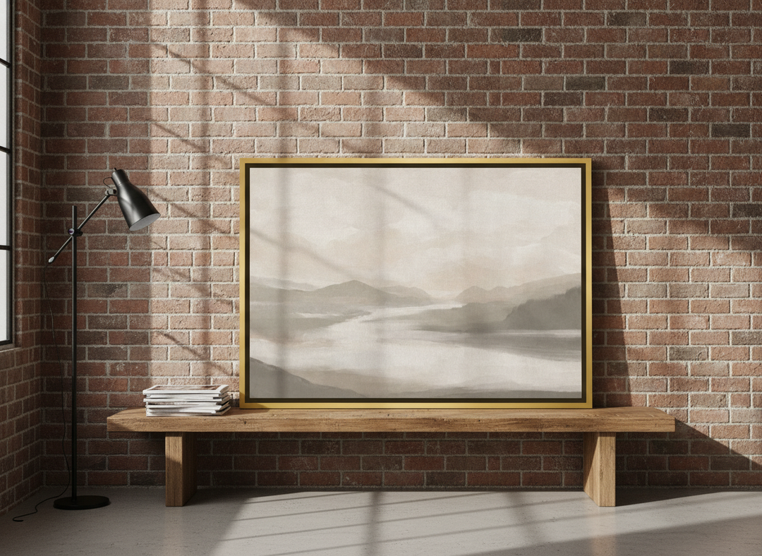 Canvas wall art with a gold leaf surround standing on a bench in an industrial loft home office