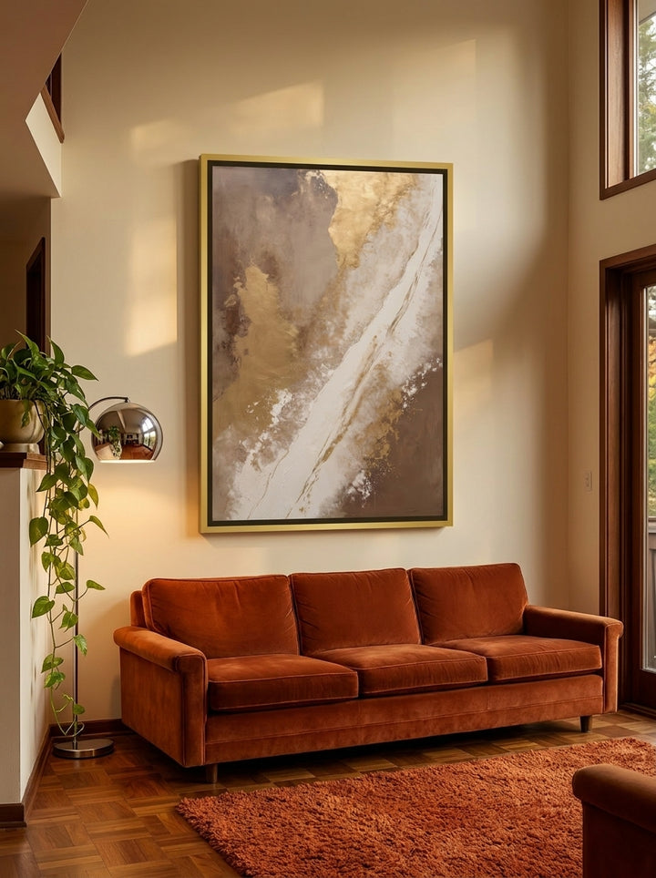 Oversized statement canvas wall art with a gold leaf surround styled on the wall in a retro 70s living room