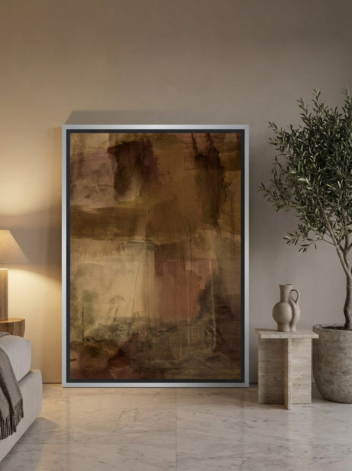 Oversized statement canvas wall art with a silver leaf surround leaning against the wall in a luxe bedroom