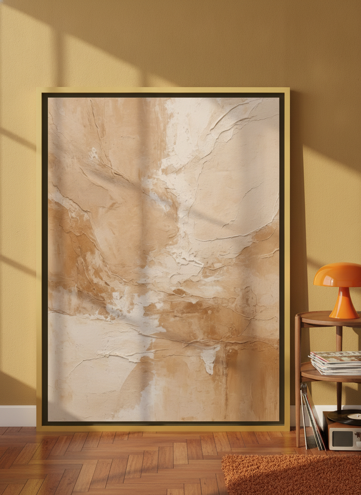 Canvas wall art with a gold leaf surround leaning against the wall in a retro 70s home office