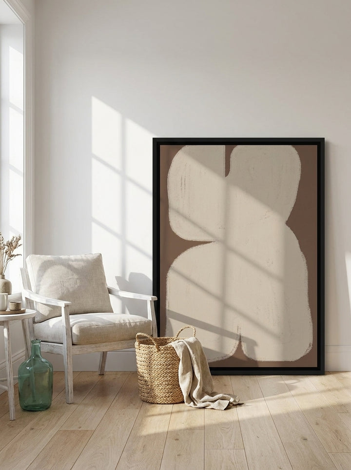 Canvas wall art with a black surround leaning against the wall in a coastal living room