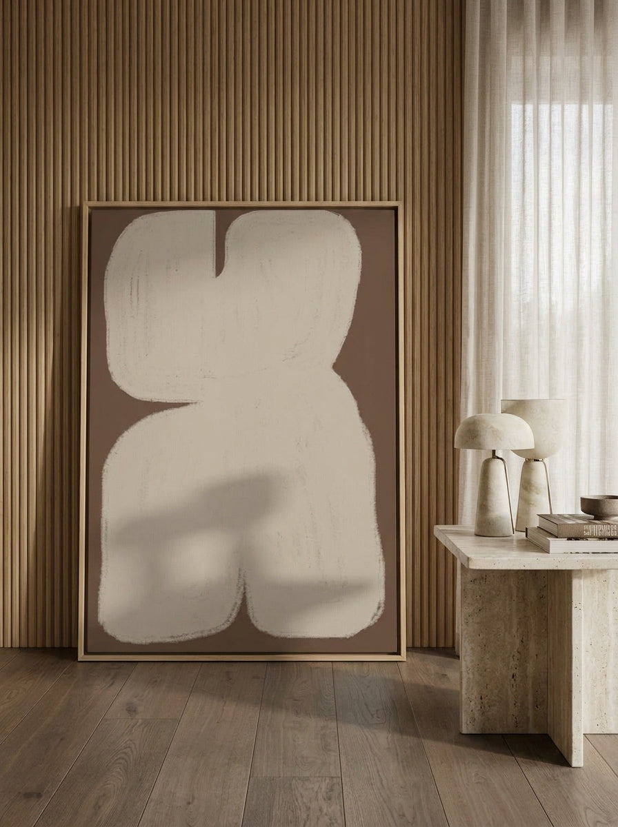 Oversized statement canvas wall art with a natural timber surround leaning against the wall in a luxe bedroom