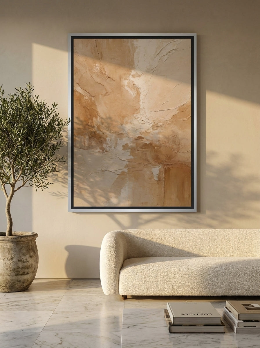Oversized statement canvas wall art with a silver leaf surround styled on the wall in a luxe living room