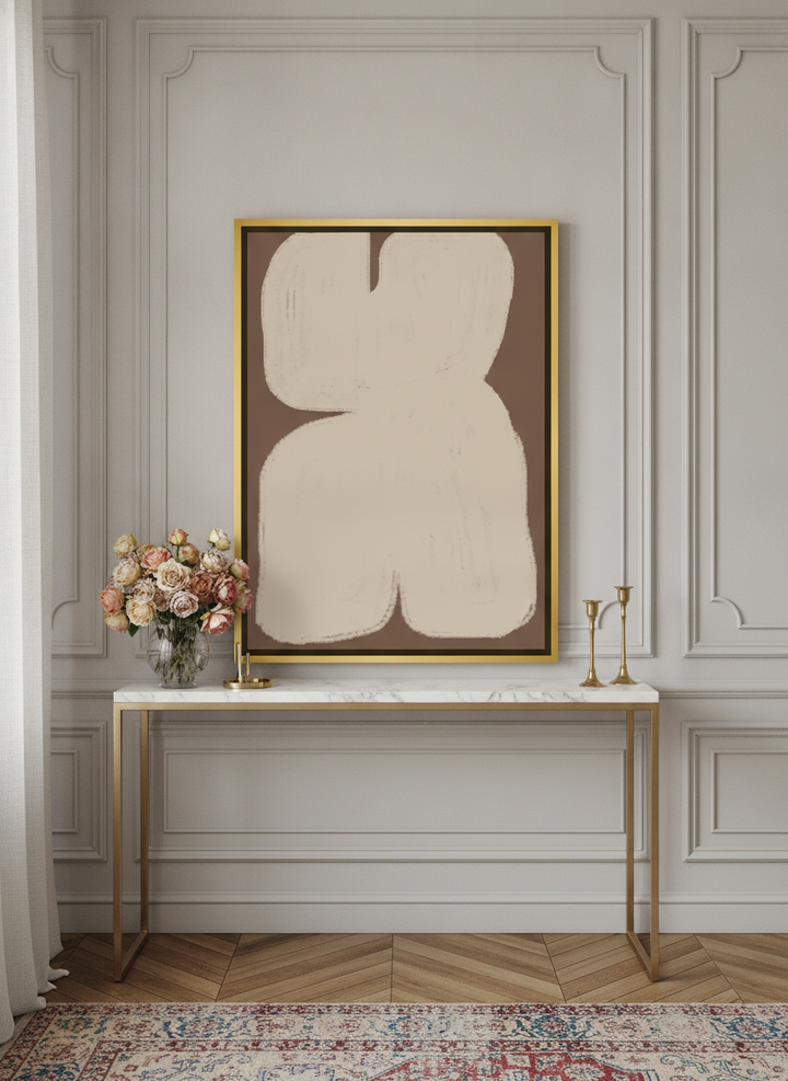 Canvas wall art with a gold leaf surround standing on a console in a Parisian home office