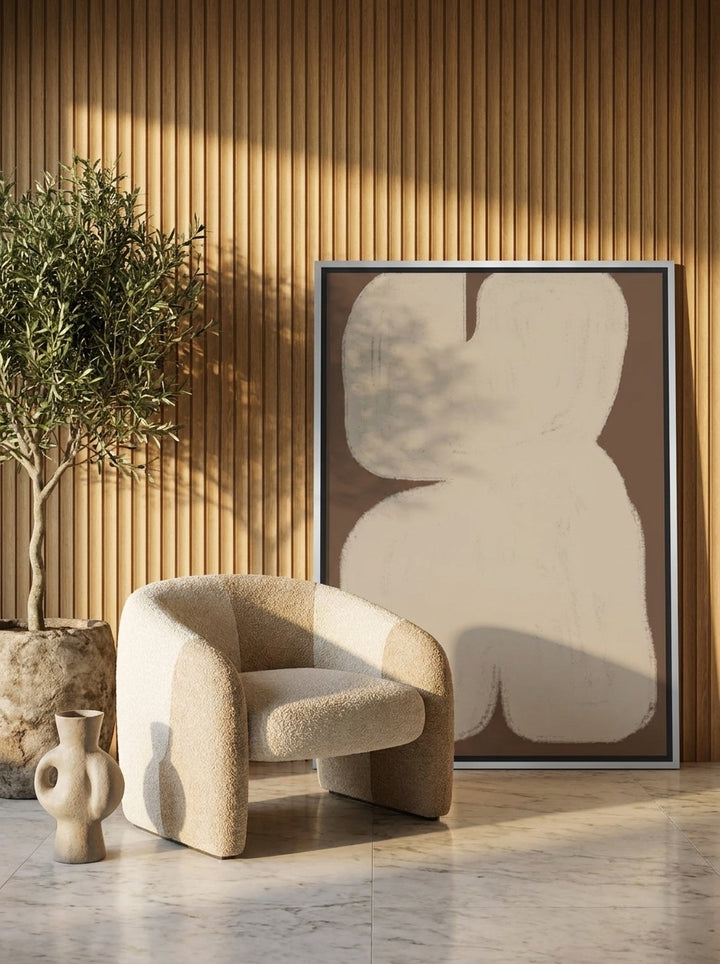 Oversized statement canvas wall art with a silver leaf surround leaning against the wall in a luxe dining room