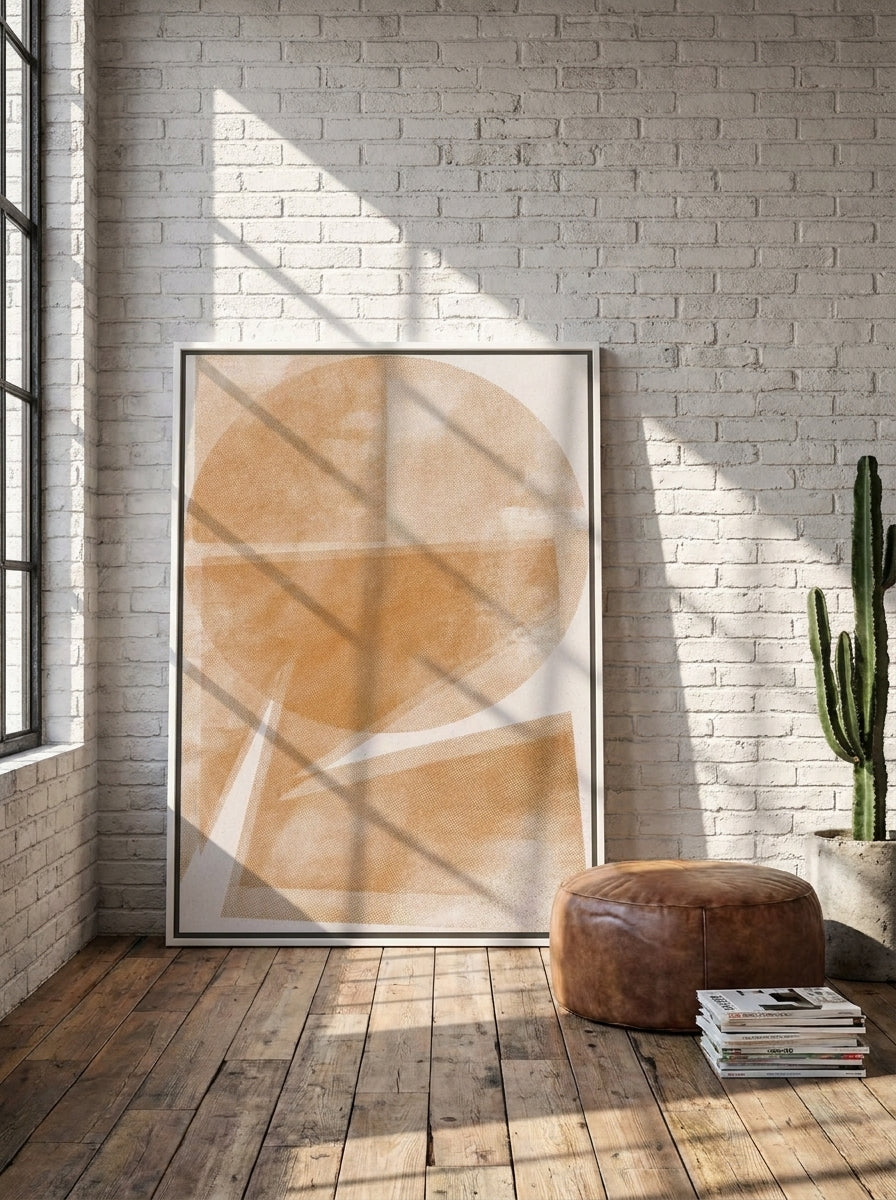 Oversized statement canvas wall art with a white surround leaning against the wall in an industrial loft living room
