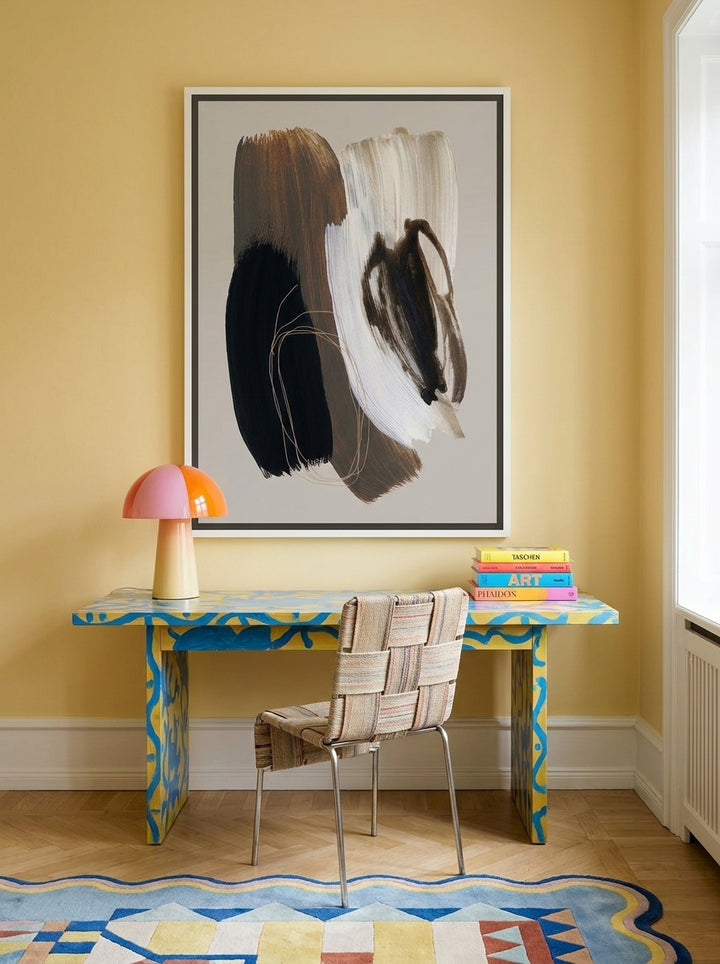 Canvas wall art with a white surround styled on the wall in a colourful eclectic home office