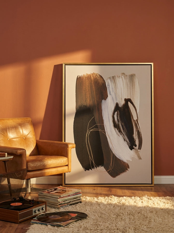 Canvas wall art with a gold leaf surround leaning against the wall in a retro 70s bedroom