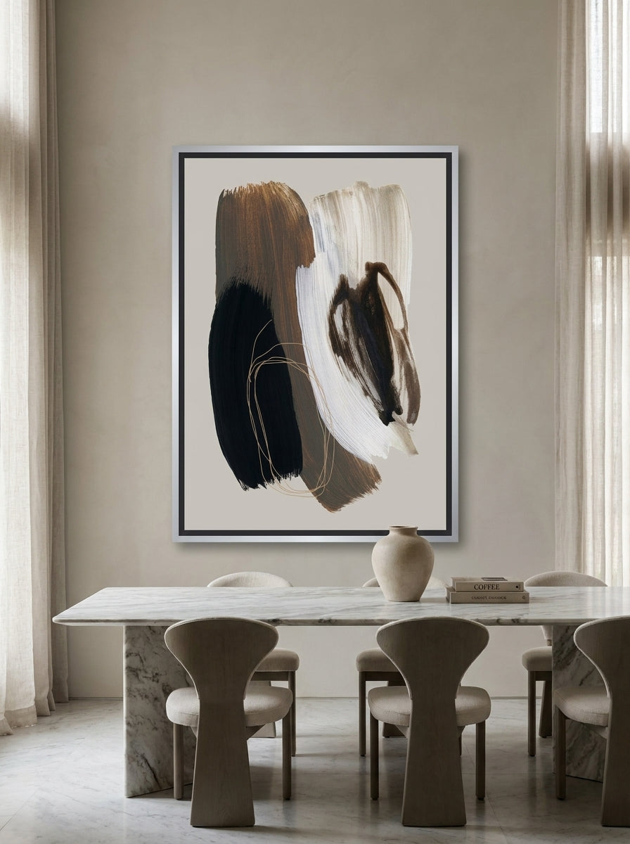 Oversized statement canvas wall art with a silver leaf surround styled on the wall in a luxe dining room
