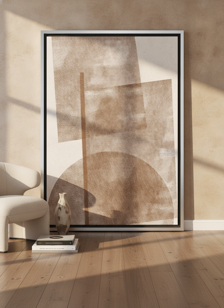 Oversized statement canvas wall art with a silver leaf surround leaning against the wall in a luxe dining room