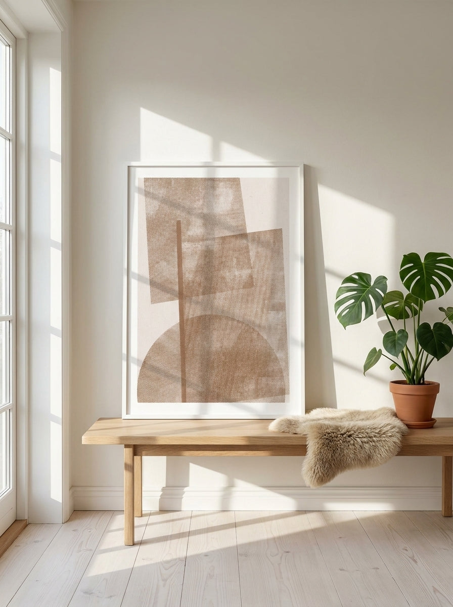 Modern wall art print standing on a bench in a bright Scandinavian bedroom