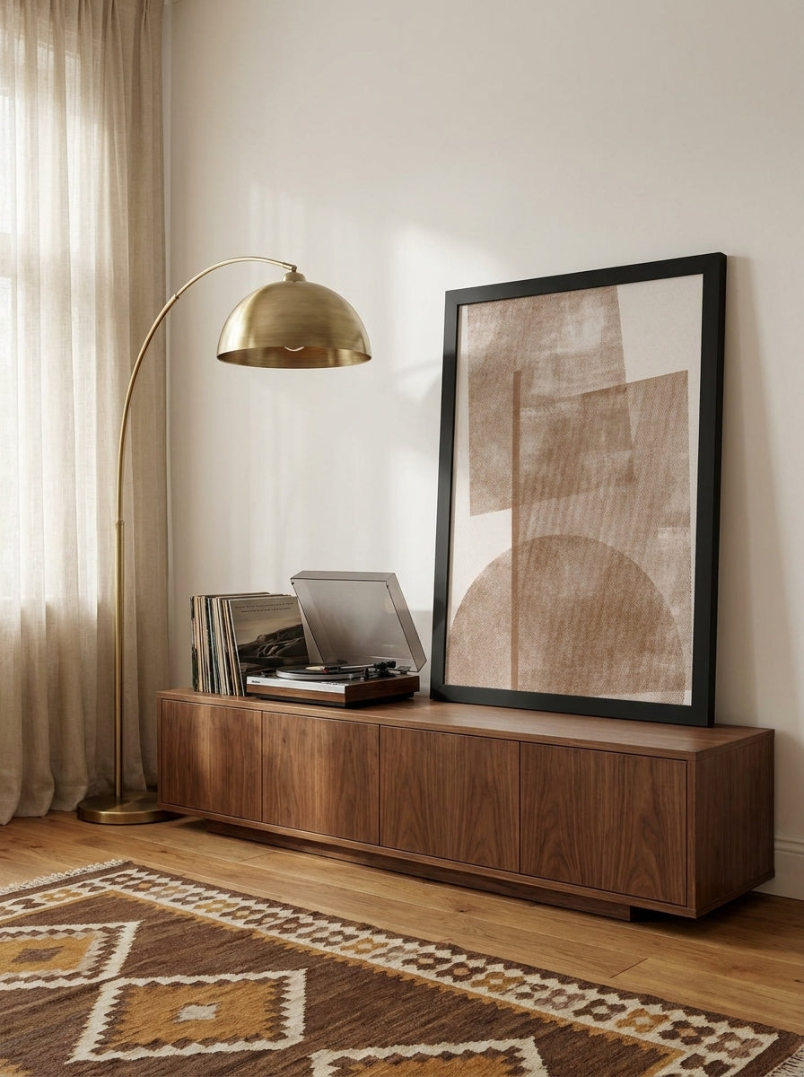Modern wall art print standing on a sideboard in a mid-century living room
