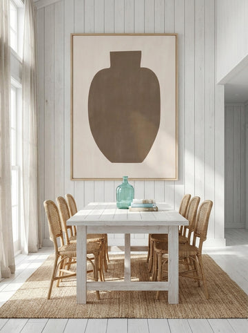 Oversized statement modern wall art print styled on the wall in a coastal dining room