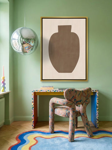 Canvas wall art with a gold leaf surround styled on the wall in a colourful eclectic home office