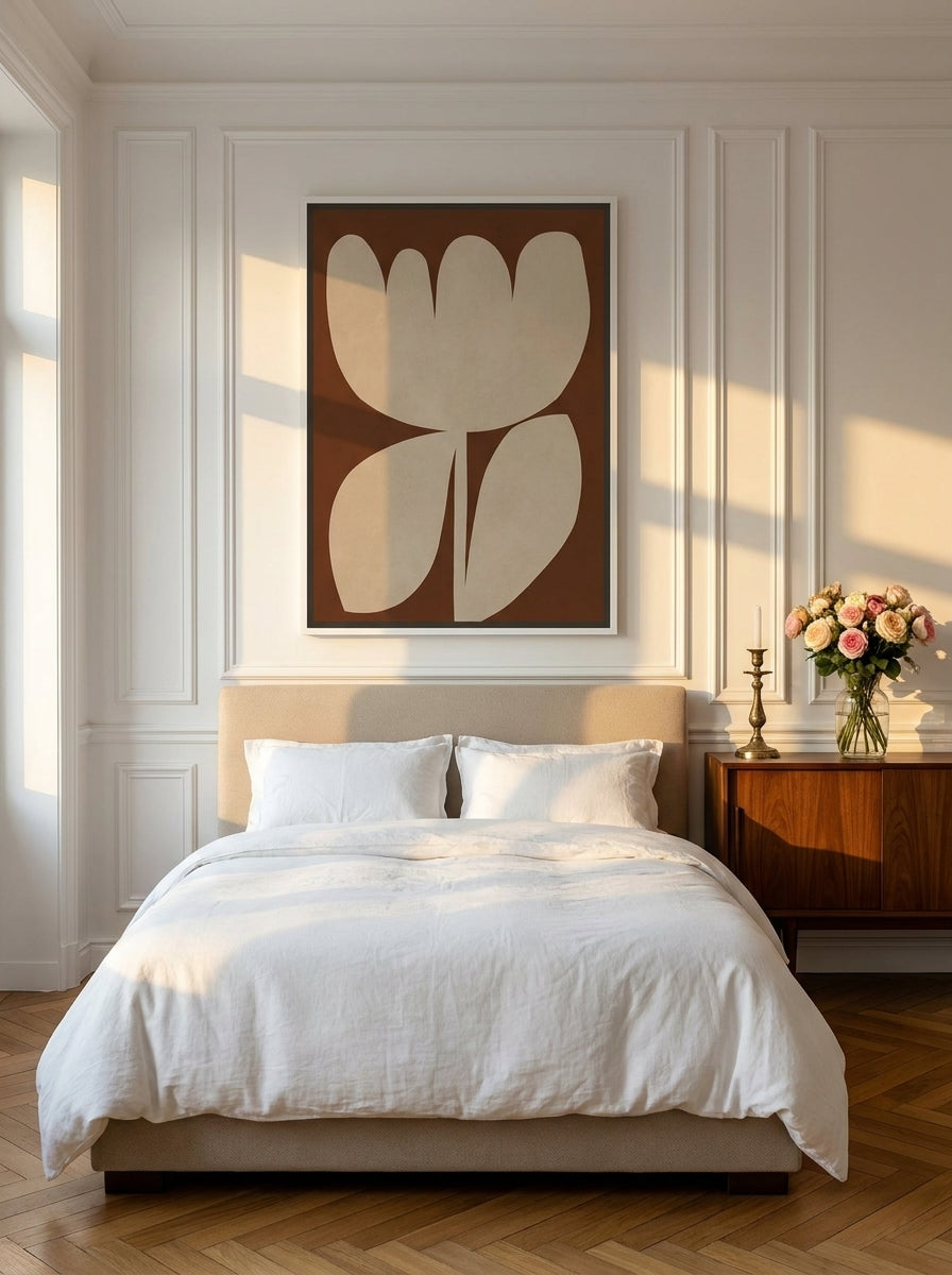 Canvas wall art with a white surround styled on the wall in a Parisian bedroom