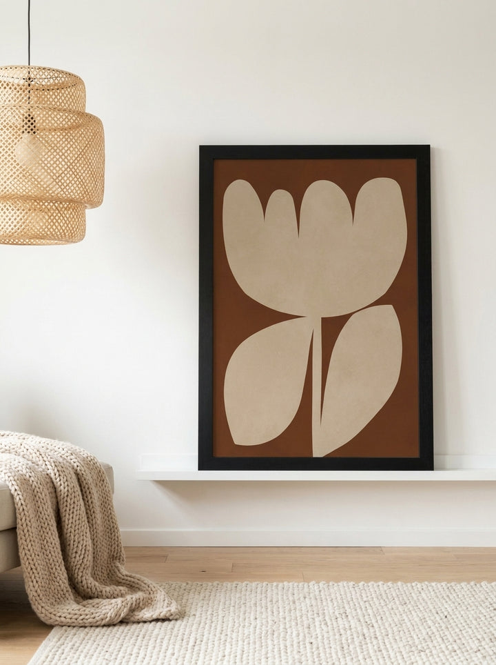 Modern wall art print standing on a shelf in a bright Scandinavian living room