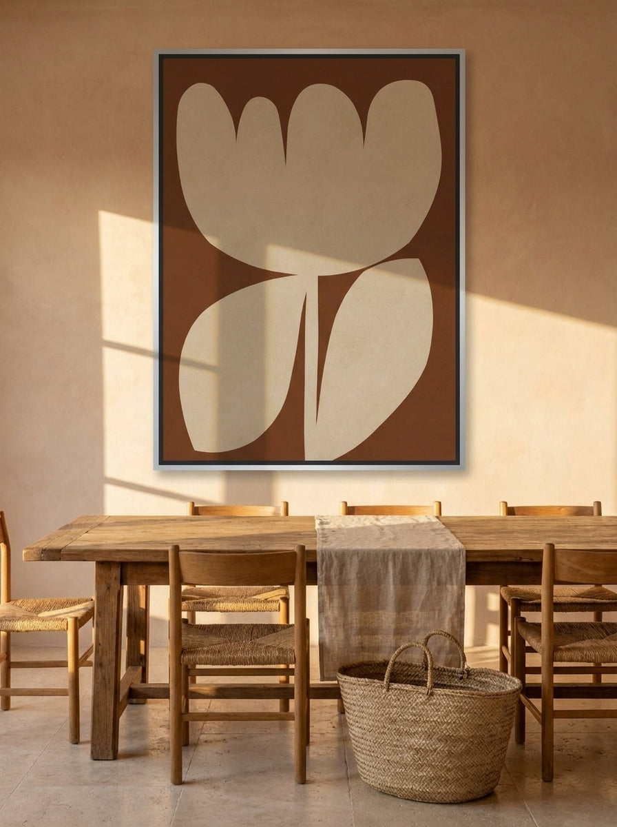 Oversized statement canvas wall art with a silver leaf surround styled on the wall in a Mediterranean dining room