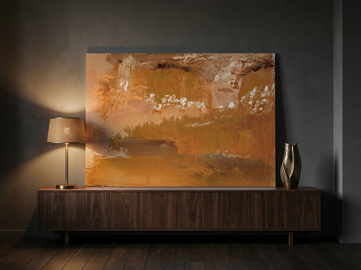 Stretched canvas wall art standing on a sideboard in a moody home office