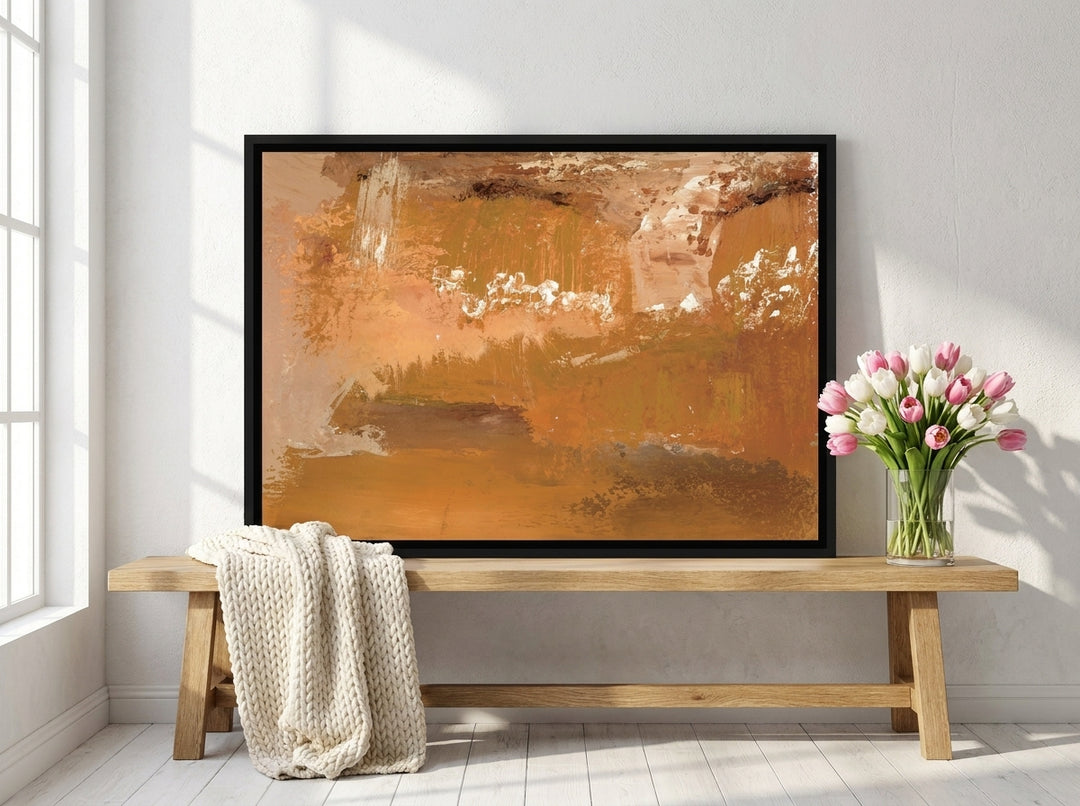 Canvas wall art with a black surround standing on a bench in a bright Scandinavian bedroom